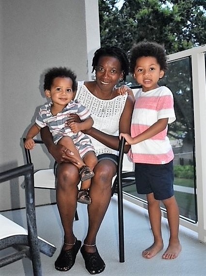 Grandma posing with grandsons on the balcony at Hilton Grand Vacations at SeaWorld in Orlando, Florida. 
