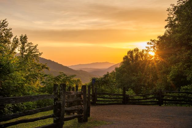 Picturesque Great Smoky Mountains lookout at sunset, mountains in the distance.