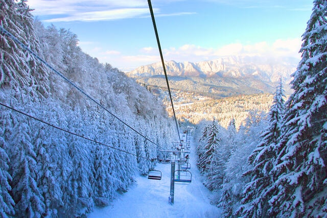 Stunning snowy scene of ski lift with snow-covered Evergreen trees on either side, Whistler, Canada. 