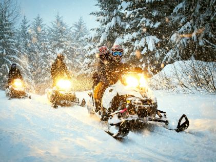 A group snowmobiles in Whistler, Canada