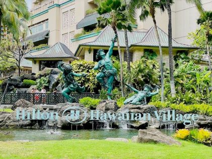 The lush sign and statues of Hilton Hawaiian Village
