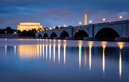 Twilight visual of the Arlington Memorial Bridge over the Potomac River with the National Mall in the background, Washington, D.C.