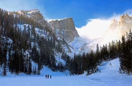 Snowshoers, surrounded by snow, blue skies, Colorado Rocky Mountains. 