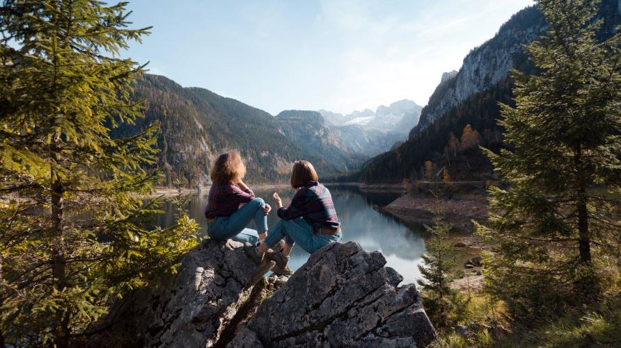 Two women admiring gorgeous mountain lake view, Mont-Tremblant, Quebec, Canada. 